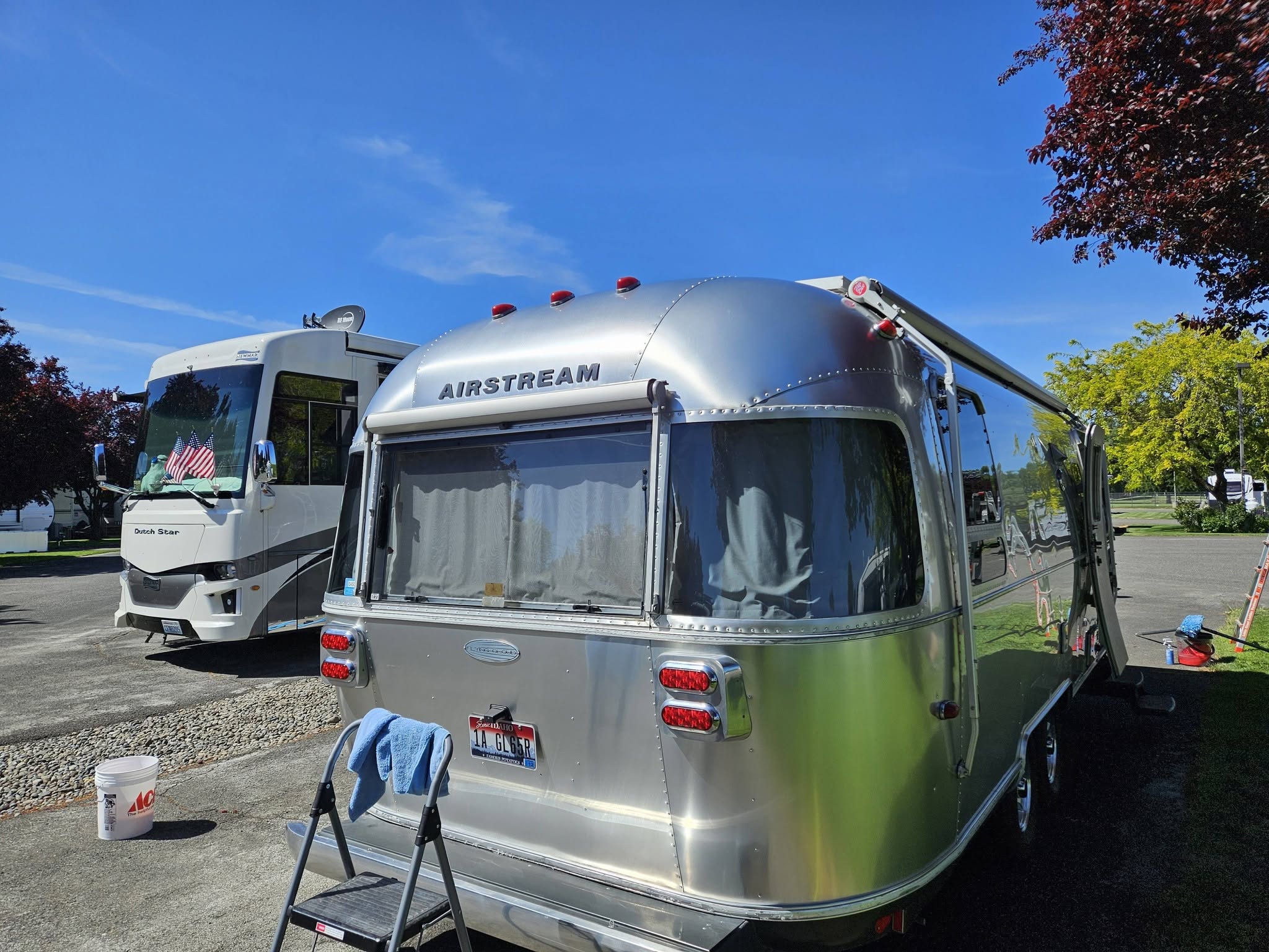 Clean Airstream trailer parked at a campsite